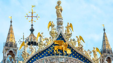 St Mark`s Basilica in Venice, Italy. Famous Saint Mark`s cathedral is top tourist attraction of Venice. Old building with beautiful mosaics and statues. Luxury Renaissance facade of Venice landmark.