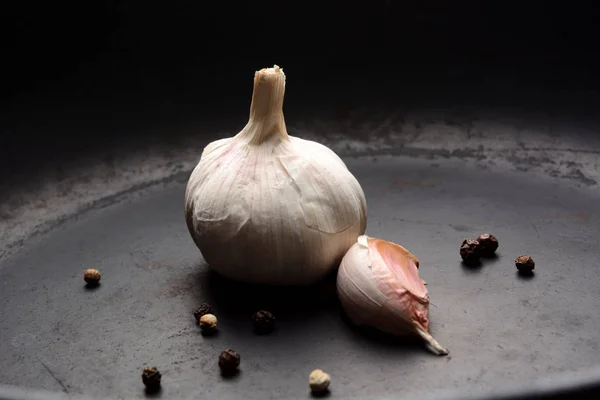 Garlic with pepper on a dark background — Stock Photo, Image