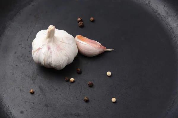 Garlic with pepper on a dark background — Stock Photo, Image