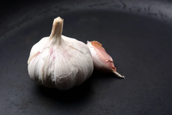 Garlic with pepper on a dark background — Stock Photo, Image