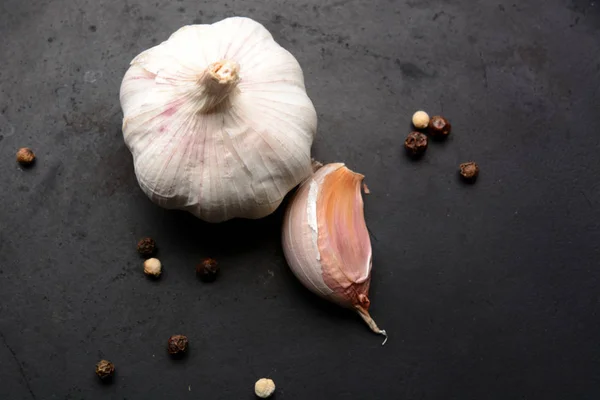 Garlic with pepper on a dark background — Stock Photo, Image