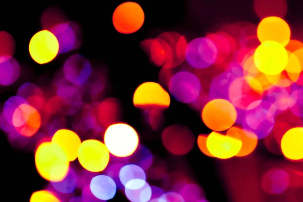 Kolorowe kółka bokeh świąteczny blask ciemne tło — Zdjęcie stockowe