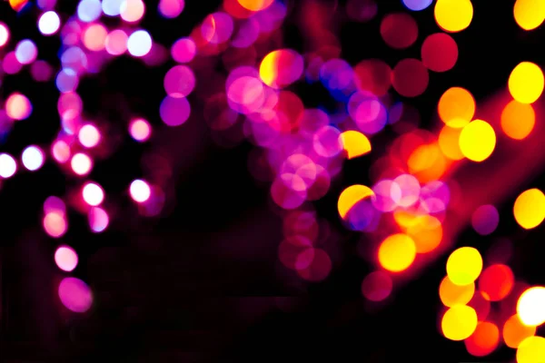 Kolorowe kółka bokeh świąteczny blask ciemne tło — Zdjęcie stockowe