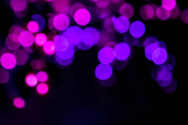 Círculos rosados brillantes bokeh festivo brillo fondo oscuro — Foto de Stock