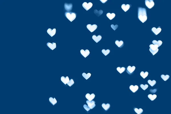 Fondo festivo de color azul con corazón blanco bokeh — Foto de Stock