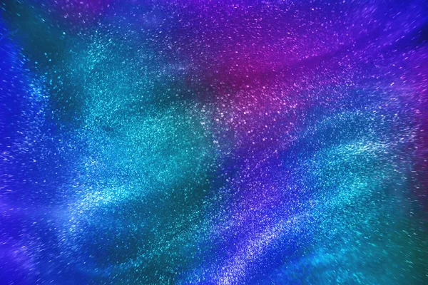 Abstract Neon Rainbow Colored Glitter Particles Flow Shallow Depth Field — Fotografia de Stock