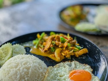 Close up fried pork curry with fried eggs local food Thai style backgrounds