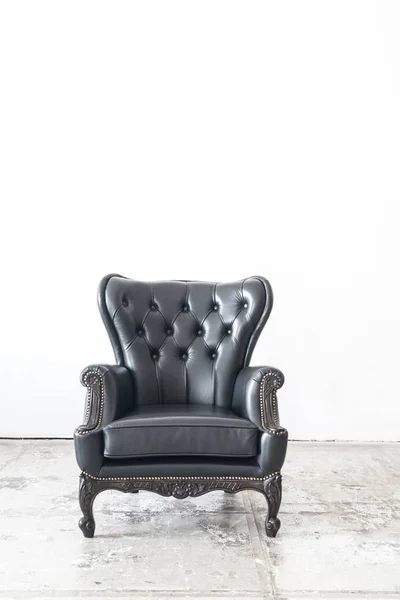 vintage armchair on white wall.