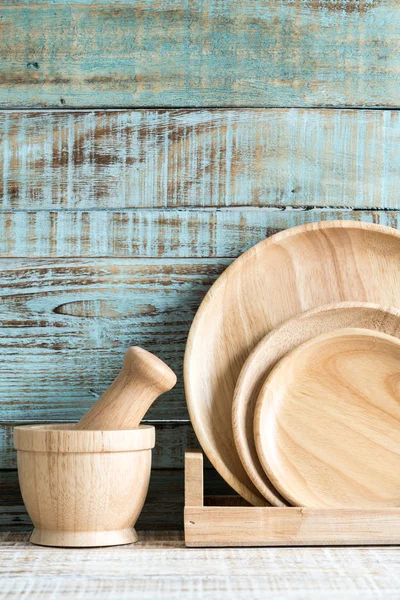 Kitchen cooking utensils in storage on the wood background