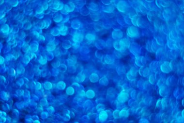 Mavi parlak arka plan. Bokeh. Parıltı. Pullu taraf. Klasik mavilik. Sihir