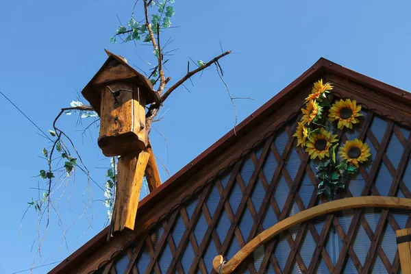 Old style birdhouse on wooden roof — Stock Photo, Image