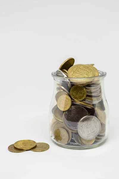 Ukrainian UAH money in a glass jar, isolate on a white background.