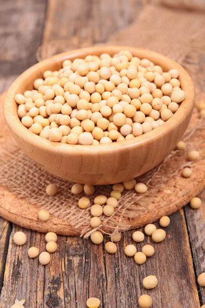 Soy bean on wooden plate — Stock Photo, Image