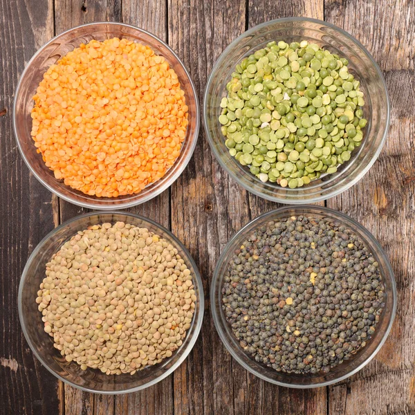 Assorted lentils in glass bowls — Stock Photo, Image