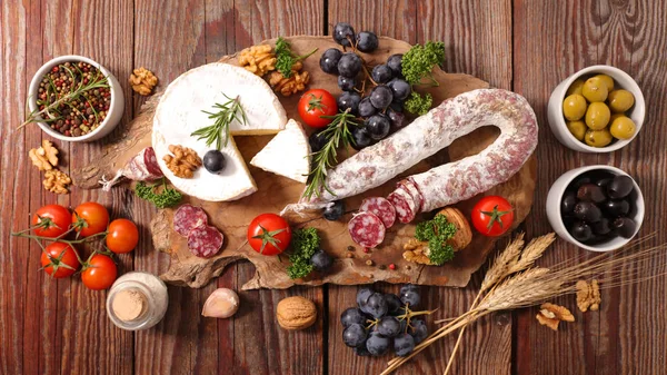 Charcuterie and cheeses top view — стоковое фото