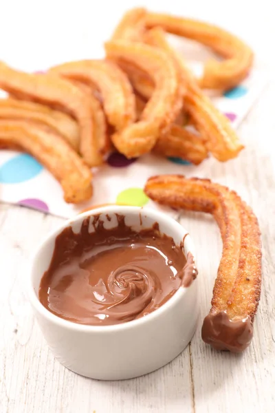 Churros with chocolate sauce — Stock Photo, Image