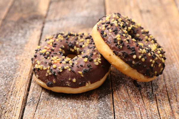 Chocolate Donuts on wooden table — Stock Photo, Image