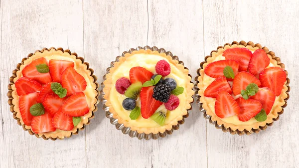 Strawberry tarts on wooden table — Stock Photo, Image