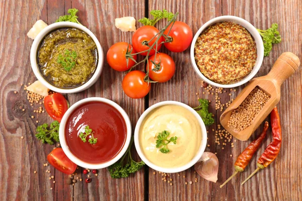 Assorted sauces on wooden background — Stock Photo, Image