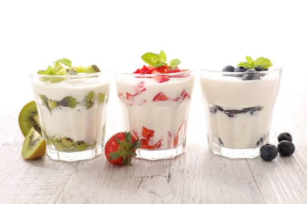 Yogurts and fruits on table — Stock Photo, Image