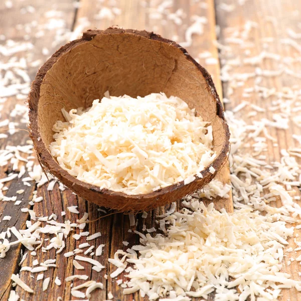 Coconut shavings in coconut shell — Stock Photo, Image