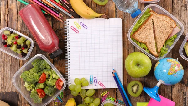 Notebook surrounded by healthy food — Stock Photo, Image