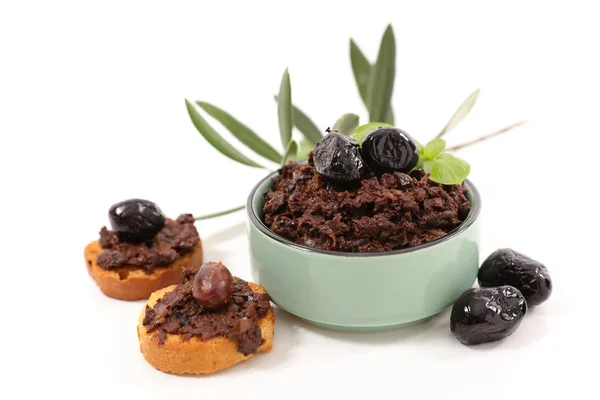 Tapenade con rami di ulivo e pane tostato — Foto Stock