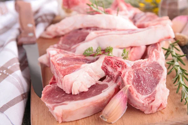 Raw lamb chop on board — Stock Photo, Image