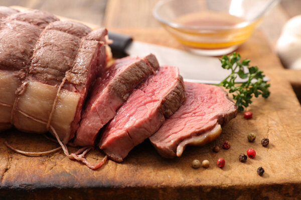 Roasted beef on wooden board