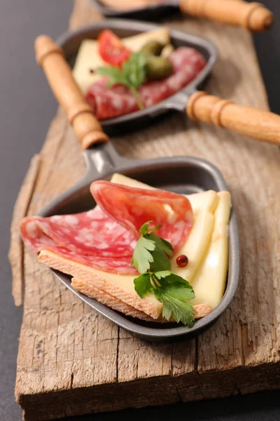 Raclette cheese and ham — Stock Photo, Image