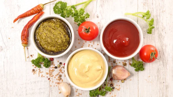 Sauces on wooden table — Stock Photo, Image