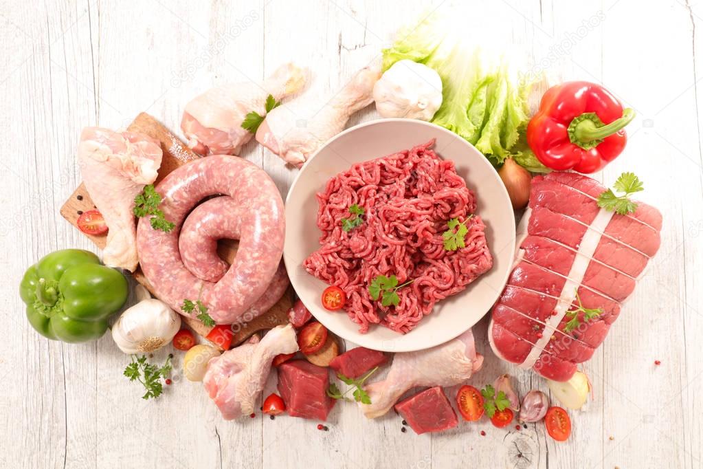 assorted raw meats on light background