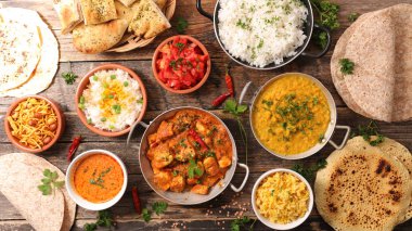 assorted indian food on wooden background clipart