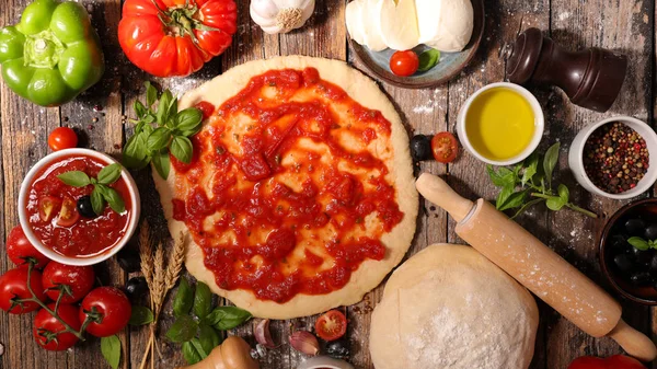 Pizza dough with tomato sauce — Stock Photo, Image