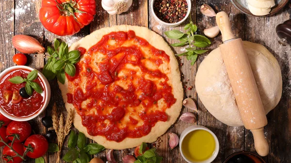 Pizza dough with tomato sauce — Stock Photo, Image