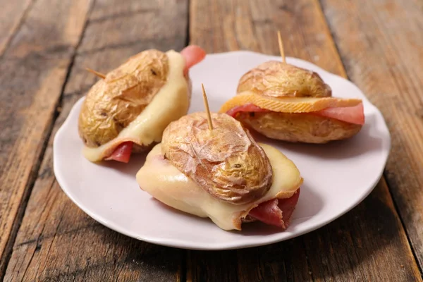 baked potato with ham and raclette cheese