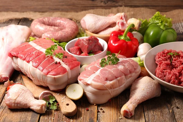 Assorted Raw Meats Wooden Table Royalty Free Stock Images