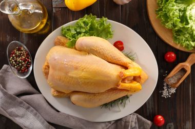 Beyaz plaka üzerinde yukarıda çiğ tavuk 