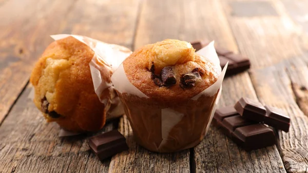 muffin with chocolate chips on wooden table