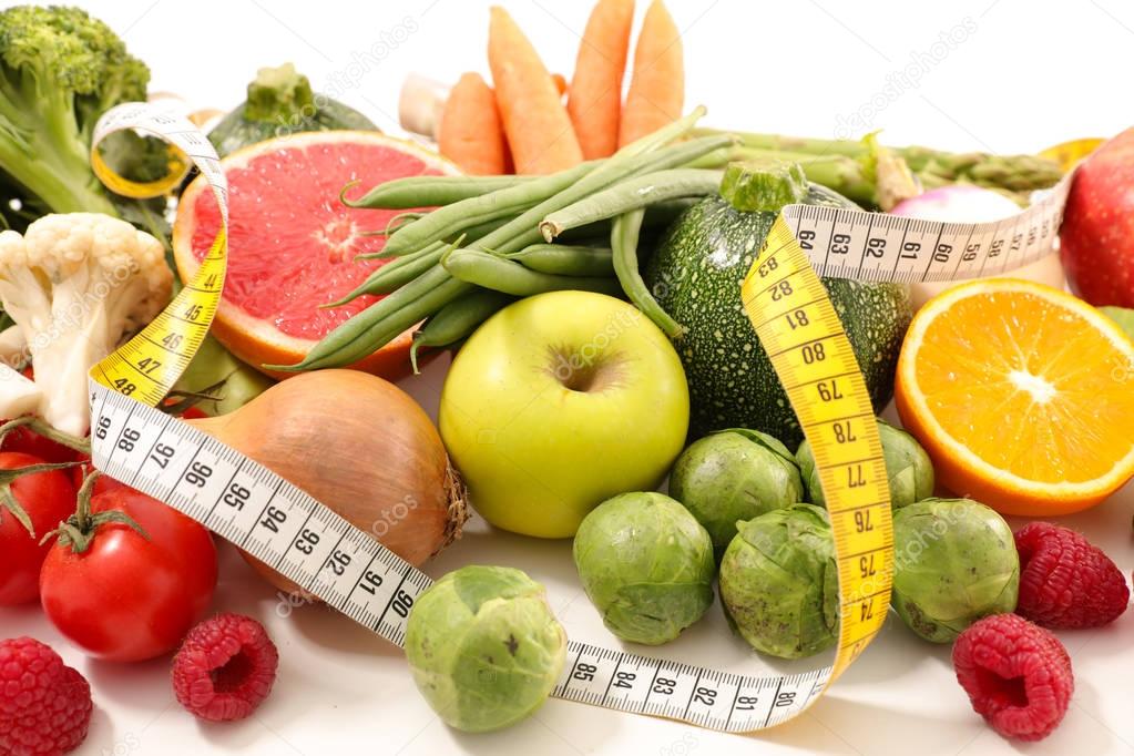 collection of fresh fruits with vegetables and measuring tape, diet food concept