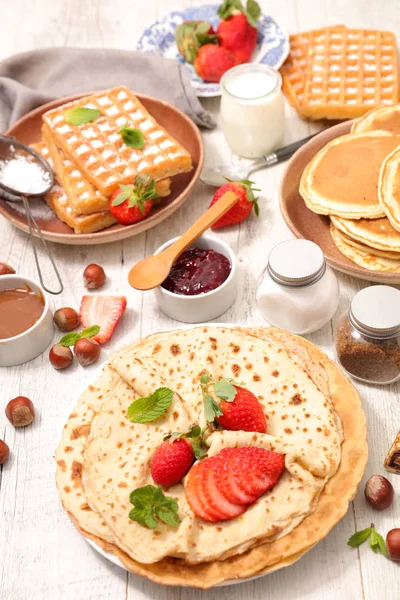 Table with crepes, waffles and pancakes