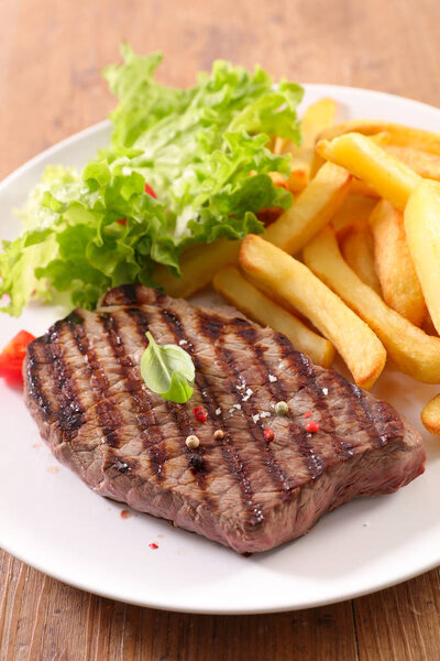 Delicious grilled meat with french fries