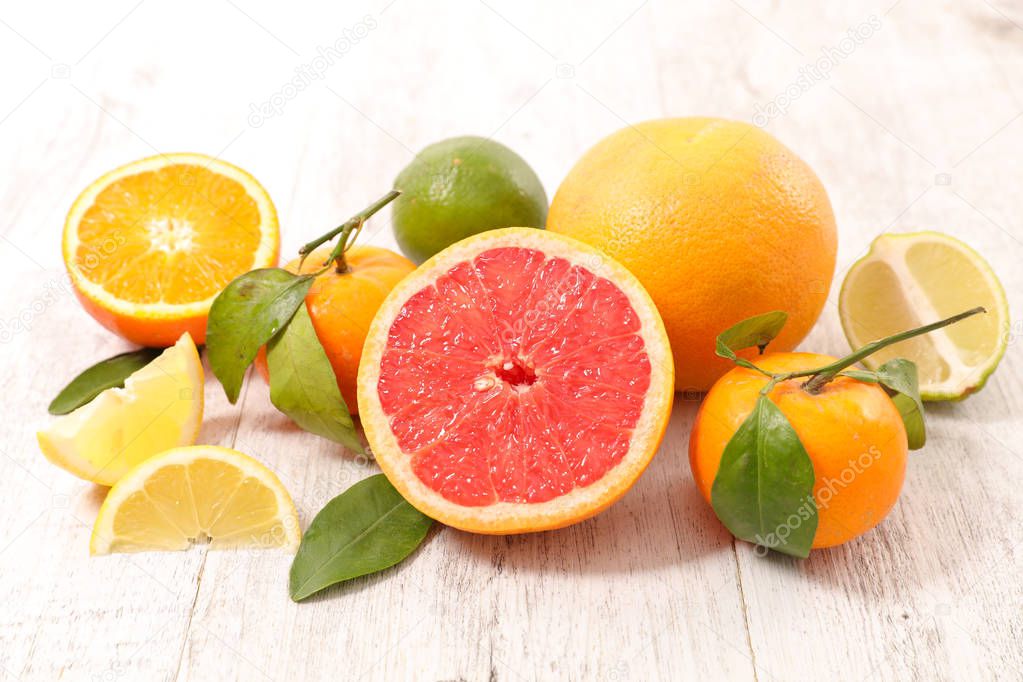 assorted fresh citrus fruits on wooden table