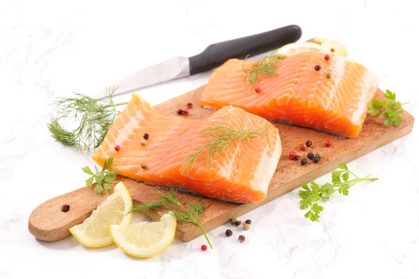 raw salmon fillet on wooden board