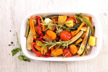 Kızarmış sebze ve ahşap arka planda bitki.