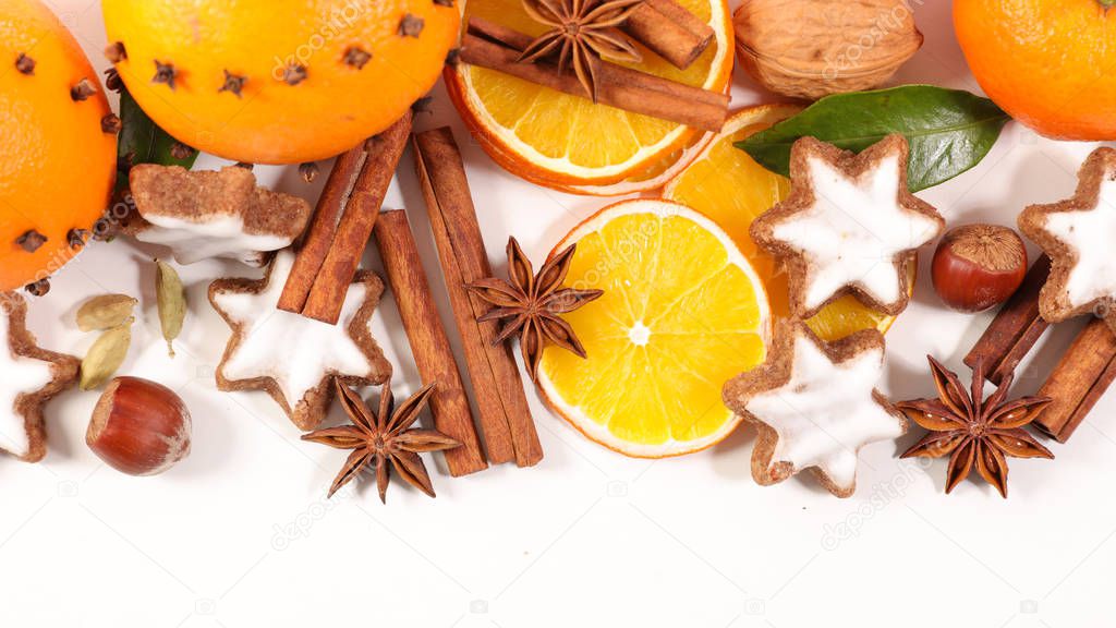 orange, cinnamon and cookies on white background