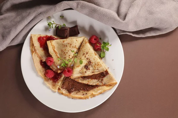 gourmet crepe with chocolate and raspberry jam