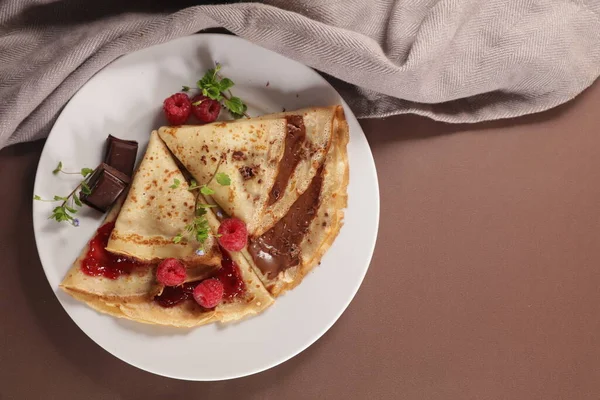 gourmet crepe with chocolate and raspberry jam