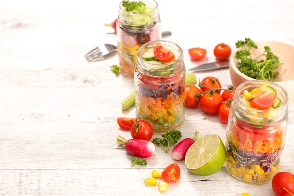 rainbow vegetable salad in jar and ingredient