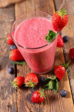 Ahşap arka planda meyveli smoothie.